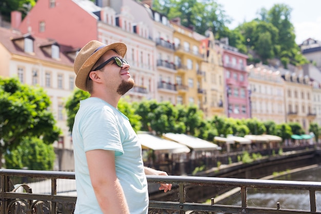 Young handsome man in old european town traveler summer people and journey concept