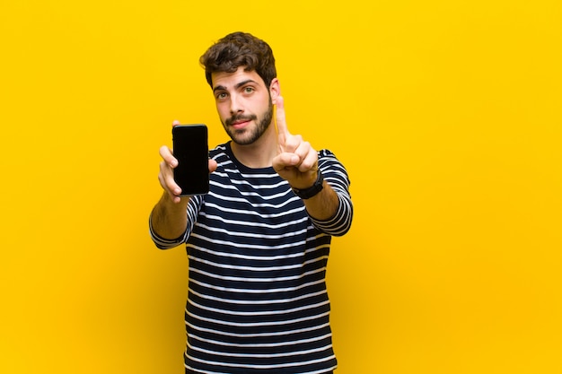 Young handsome man on orange