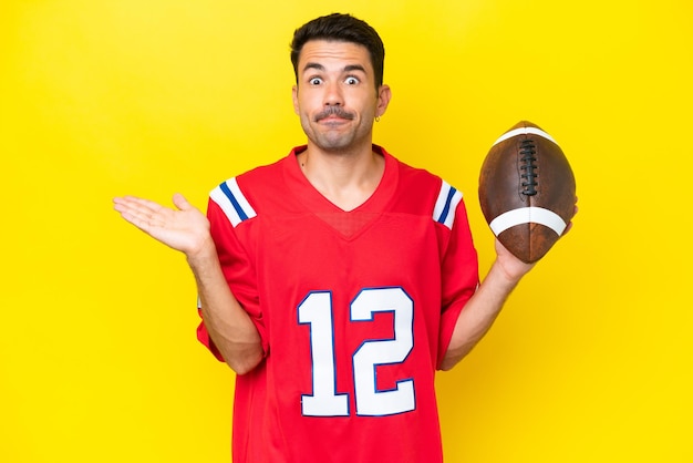 Young handsome man playing rugby over isolated yellow background having doubts while raising hands