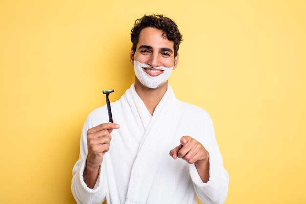 Young handsome man pointing at camera choosing you. shaving and foam concept