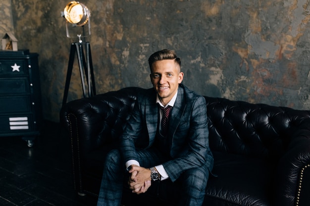 Young handsome man posing for a fashion shoot in a studio