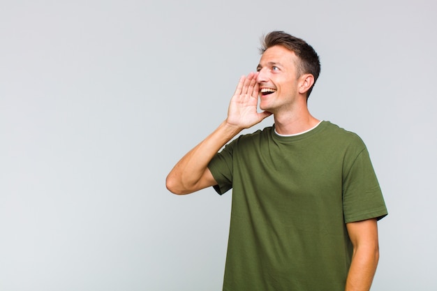 Young handsome man profile view, looking happy and excited