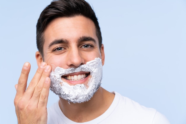 Young handsome man shaving his beard