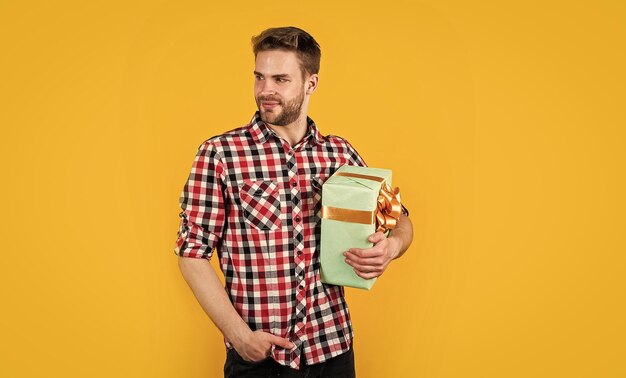 Young handsome man in shirt hold present box anniversary