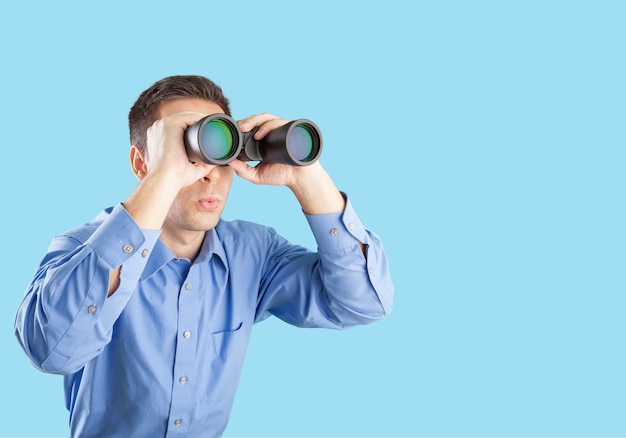 Young handsome man in shirt  with binoculars