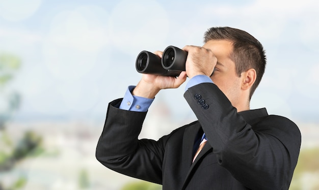 Young handsome man in shirt  with binoculars