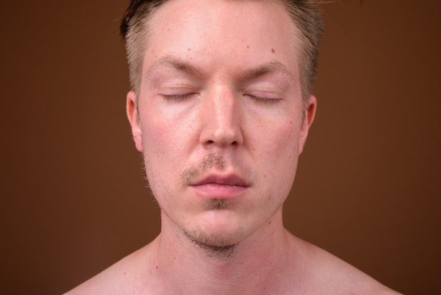 young handsome man shirtless while grooming 