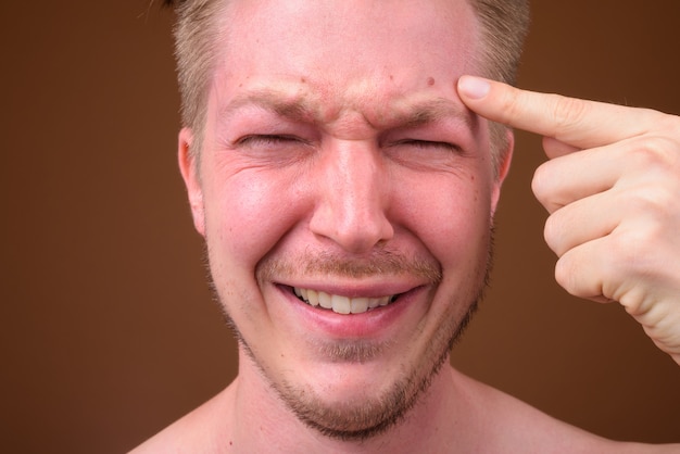 young handsome man shirtless while grooming 