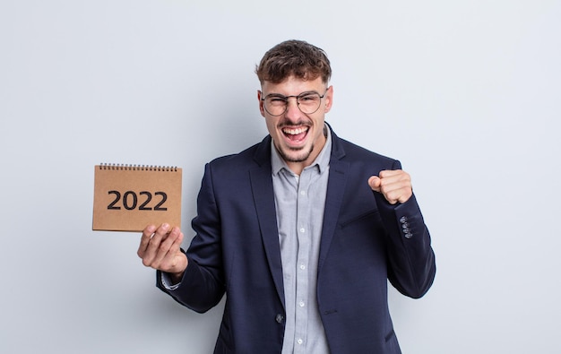 Young handsome man shouting aggressively with an angry expression. calendar concept