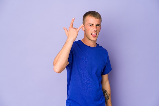 Young handsome man showing rock gesture with fingers