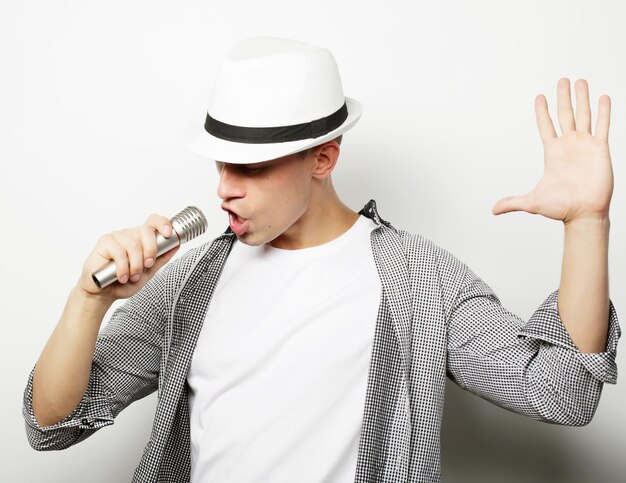 young handsome man singing with microphone