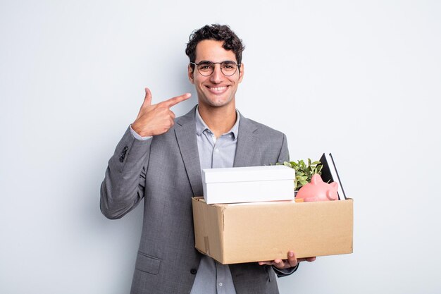 Young handsome man smiling confidently pointing to own broad smile dismissal concept