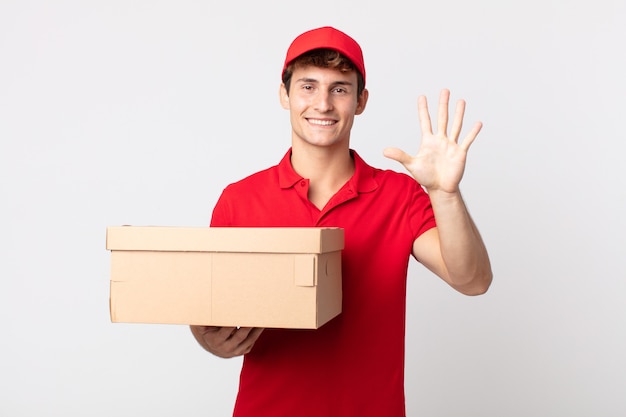 Young handsome man smiling and looking friendly, showing number five delivery package service concept.