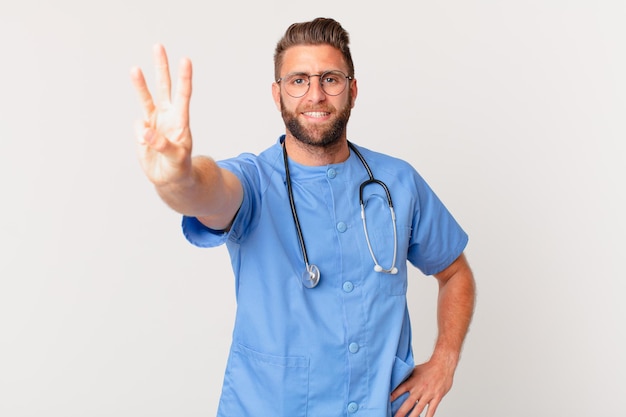 Young handsome man smiling and looking friendly, showing number three. nurse concept