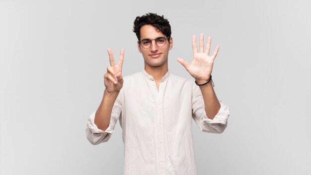 Young handsome man smiling and looking friendly