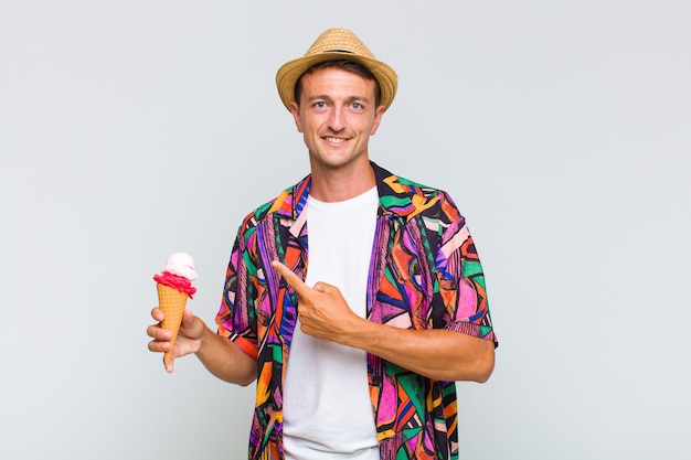 Young handsome man smiling and pointing