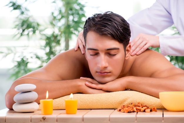 Young handsome man during spa procedure