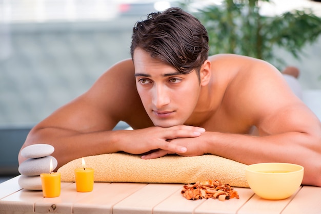 Young handsome man during spa procedure