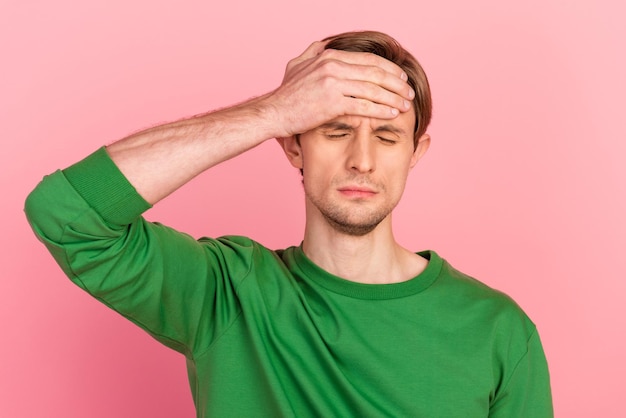 Young handsome man standing over isolated pastel background suffer headache stressed pain migraine hands on head