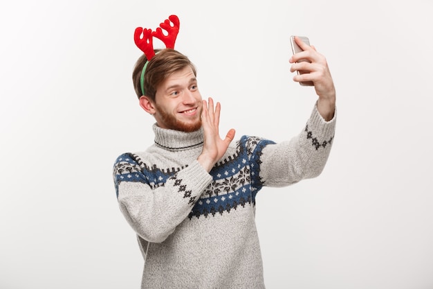 Young handsome man taking a selfie or talking facetime