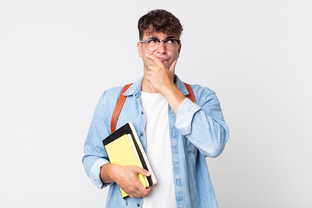 Young handsome man thinking, feeling doubtful and confused. university student concept