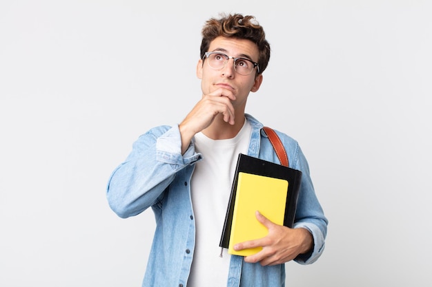 Photo young handsome man thinking, feeling doubtful and confused. university student concept