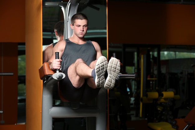 Young handsome man training in gym