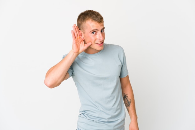 Photo young handsome man trying to listening a gossip