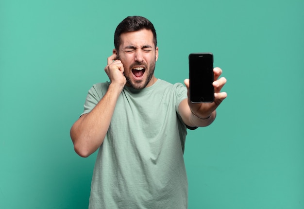 Young handsome man using his cell