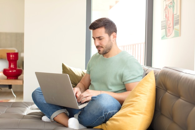 Young handsome man using a laptop