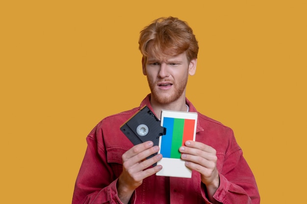 Young handsome man using retro instruments