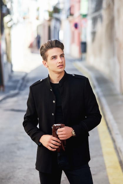 Young handsome man wearing black clothes