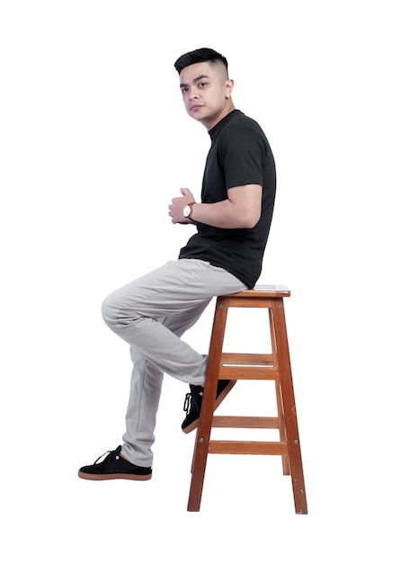 Young handsome man wearing black t shirt short sleeve was sitting in a chair