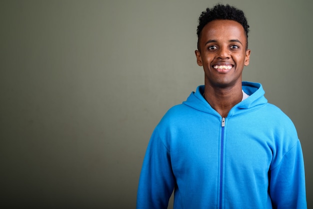 Young handsome man wearing blue hoodie