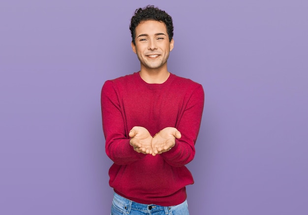 Young handsome man wearing casual clothes smiling with hands palms together receiving or giving gesture. hold and protection