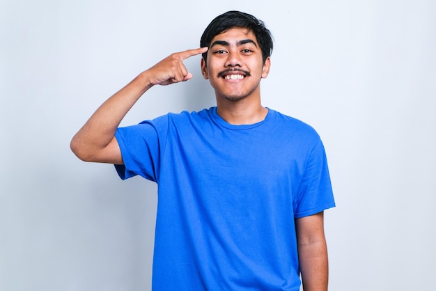 Young handsome man wearing casual shirt over white background Smiling pointing to head with one finger, great idea or thought, good memory