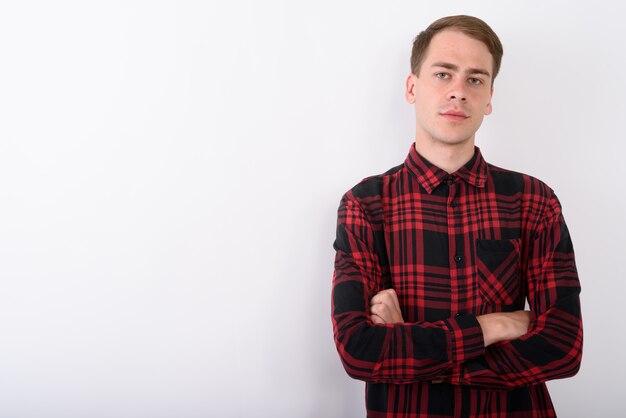 Young handsome man wearing red checkered shirt on white wall