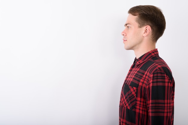 Photo young handsome man wearing red checkered shirt on white wall