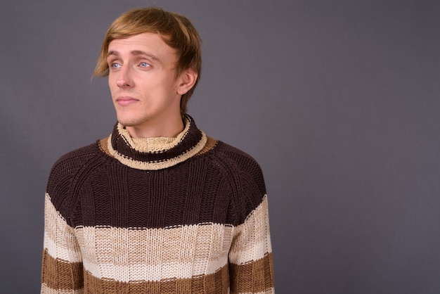 Young handsome man wearing turtleneck sweater