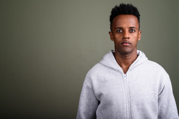 Young handsome man wearing white hoodie