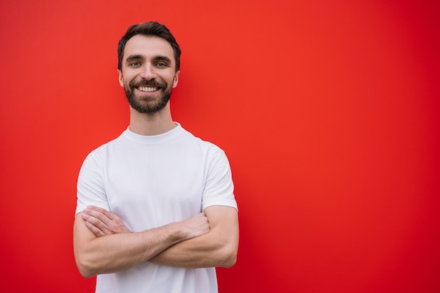 Young handsome man with arms crossed wearing casual t-shirt isolated on background