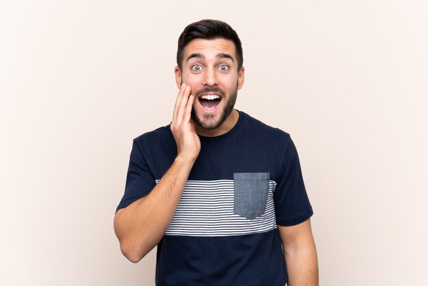 Young handsome man with beard isolated with surprise and shocked facial expression