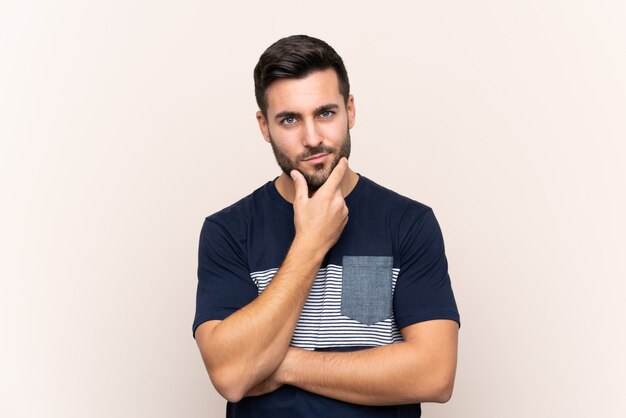 Young handsome man with beard over isolated