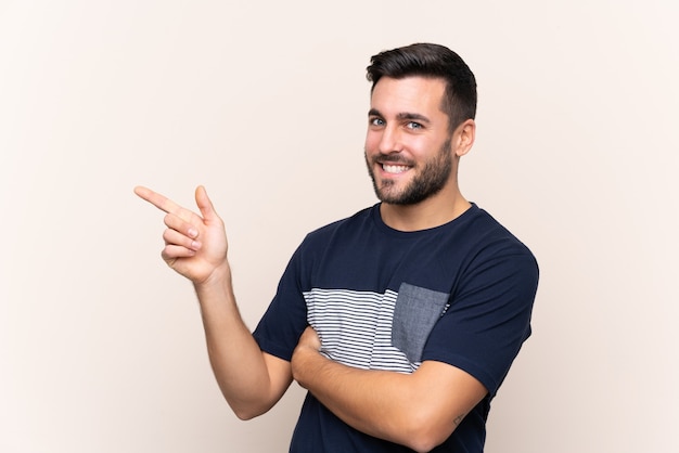 Young handsome man with beard over isolated