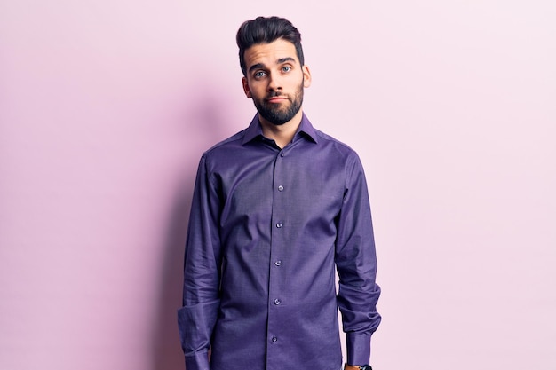 Young handsome man with beard wearing casual shirt looking sleepy and tired exhausted for fatigue and hangover lazy eyes in the morning