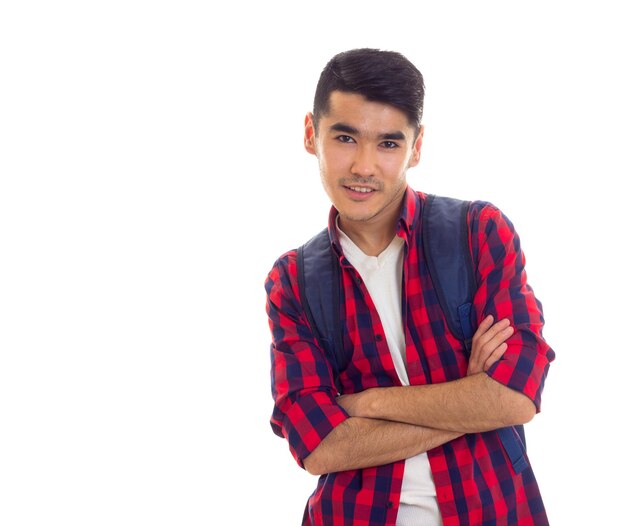 Young handsome man with black hair with blue backpack and folder with copybooks