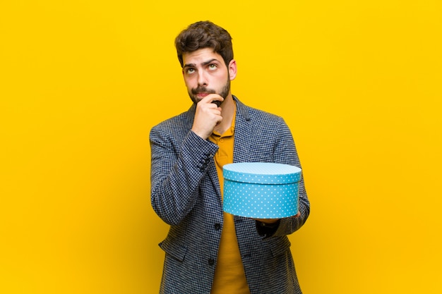 Young handsome man  with a box