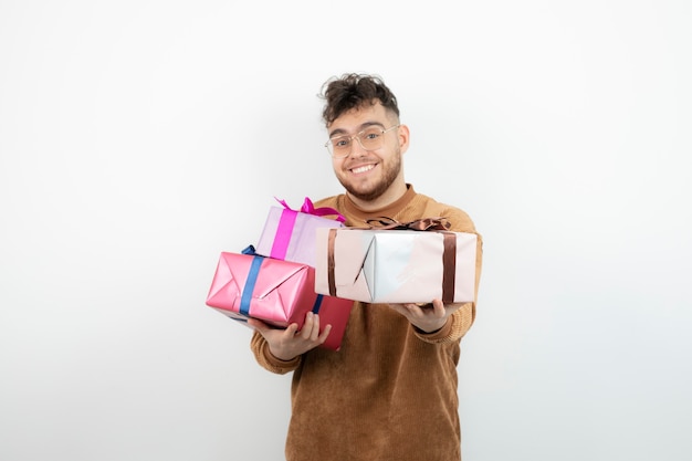 Young handsome man with gift boxes feeling happy. 