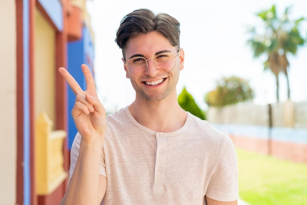 Young handsome man With glasses and doing OK sign