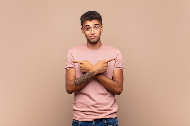 young handsome man with his arms crossed and raising index finger